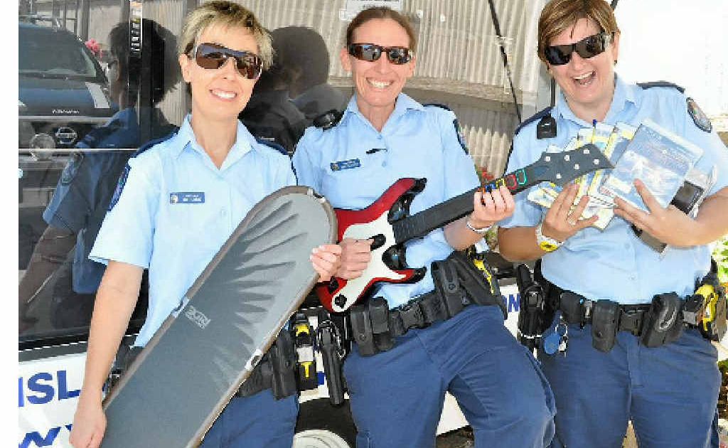 Constables Jade Fleming, Kirstyn Lister and Fiona Scott show off some of the Playstation games which will be available for children at the Blue Light disco. 